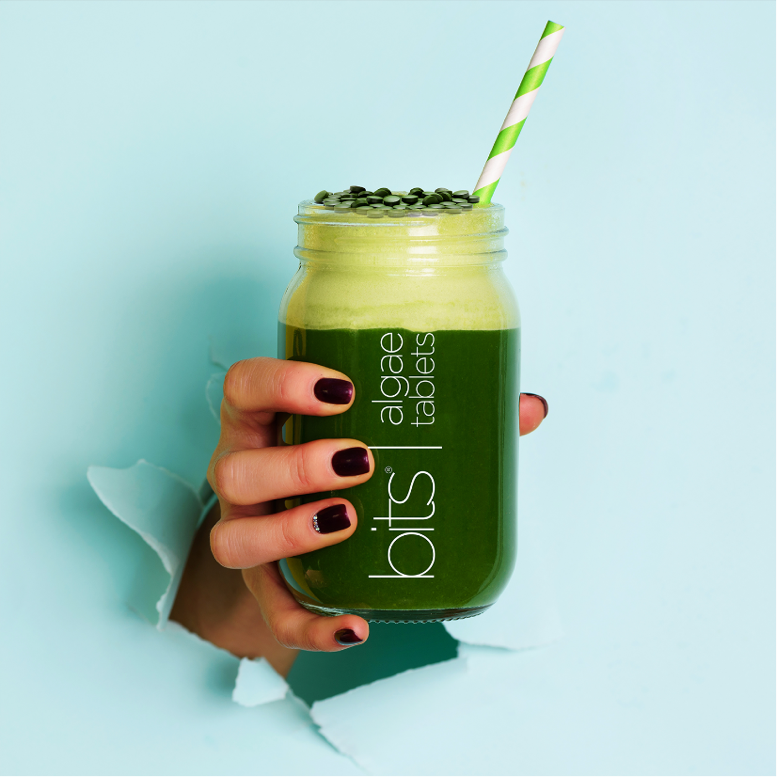 hand holding green smoothie