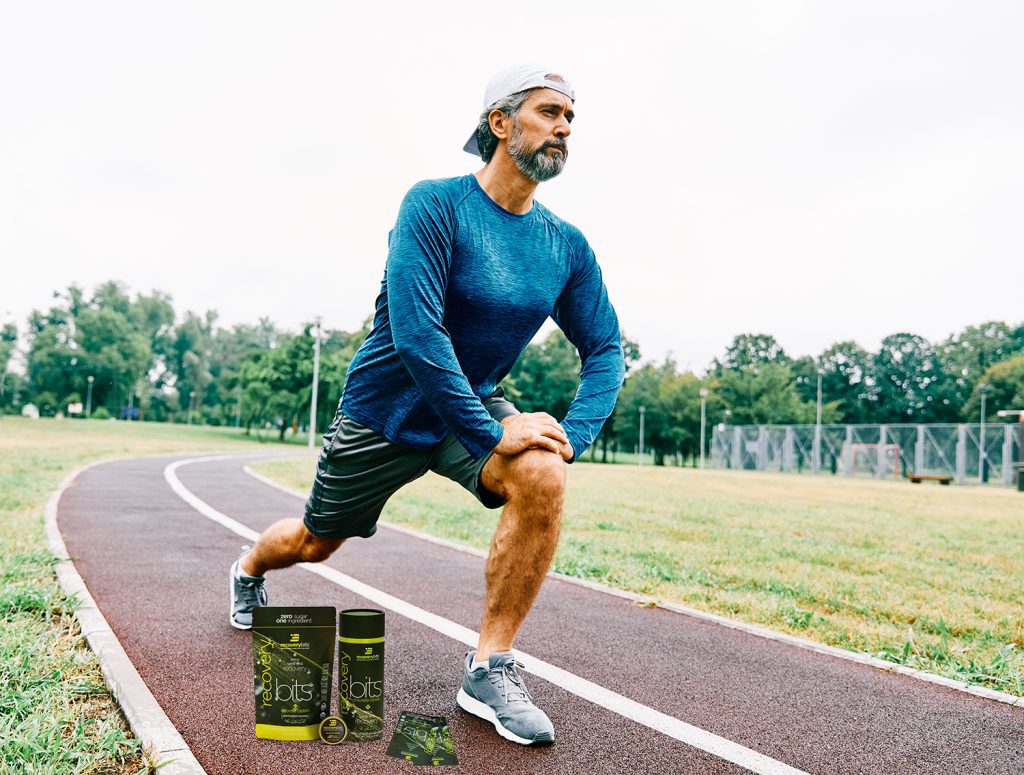 man stretching on track with algae products 